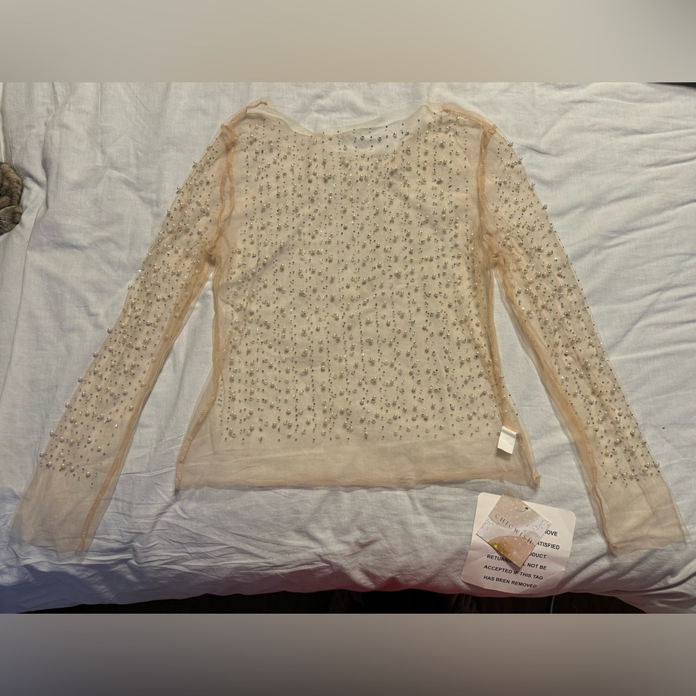 Nude sheer overlay shirt with pearls and rhinestones.